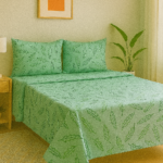 Green cotton bedsheet with leaf pattern.