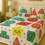 Kids cotton bedsheet with colourful cartoon shapes and smiley faces.